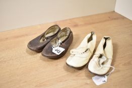 Two pairs of vintage early years' girls Mary-Jane shoes, a cream scalloped edge pair and a brown
