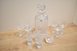 A cut glass decanter having faceted ball stopper, h25cm, sold together with 10 liqueur glasses, ( 11