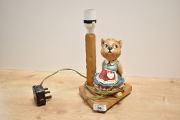 A vintage oak table lamp on triangular base with disney cat figure , h25cm