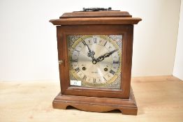 A mahogany 31 day chiming mantel clock having silvered chapter ring with Roman numerals, impressed