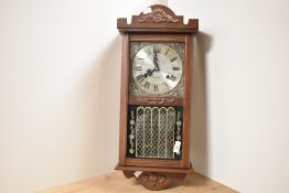 A reproduction 31 day wall clock, having silvered dial and Roman numerals, h58cm