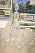 A crystal glass decanter with a selection of matching glasses