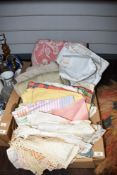 A selection of assorted linen including a woven bedcover, tablecloths and doilies etc