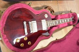 A 2002 Wine Red Gibson Les Paul Serial No 2391 Purchased by collector and never been used. Comes