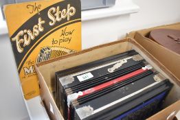 A vintage melodeon in original wood effect cardboard box