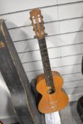 An antique Parlour guitar having later tailpiece and steel strings, no visible label, in card case