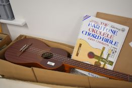 A traditional baritone ukulele , and instruction book