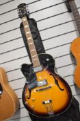 An Aria FA70 electric jazz guitar, left handed, serial number 106050407, sold with soft Warwick