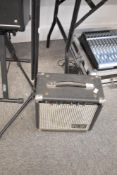 A Ross model 10 practice amplifier and a microphone stand