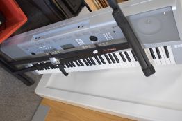 A Yamaha DGX-220 Portable Grand electronic keyboard (76 semi weighted keys) with power supply and