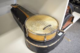 An early to mid 20th Century ukulele banjo, having 'British made' stamped to headstock, and engraved