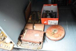 A vintage leather bound 100ft tape measure,w19cm, sold together with a cast iron thermometer, a
