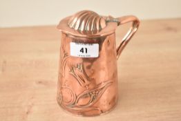An Art and crafts copper jug, embossed with floral patterns and having scallop shell lid, h13cm