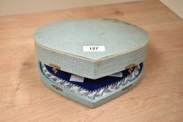 A vintage cased musical manicure set, having vanity mirror in lid, blue lined interior and dancing