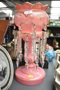 An attractive 19th century pink glass mantel lustre having cut glass spears, gilt edging and painted