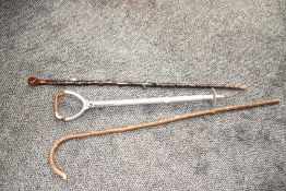 A aluminium shooting stick having leather seat, sold together with two canes, (3)