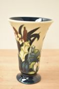 A Moorcroft pottery 'Phoenic' pattern vase of fluted form, having underglaze painted and tubeline