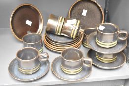 A vintage pottery tea set decorated having a green ripple base on a dark blue/green glaze ground, (