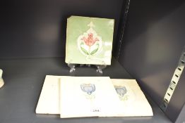 An early 20th century Henry Richards style tile, decorated with a pink poppy on a green glaze