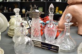 A cut glass claret jug having lion and shield finial and geometric diamond patterns, h31cm, sold