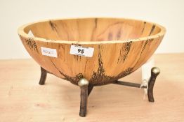 A fruit basket by Carolyn Kinder, raised on a metal support, H14.5cm