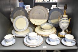 A Doulton dinner service, having gilt edge on a blue and white ground, to include plates, cups and