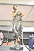 A large cast ceramic sculpture of a young classical maiden lady wearing a full toga dress, h63