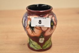 A Moorcroft pottery 'Pansies' pattern vase of lobbed form, designed by Rachel Bishop, painted and