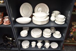 A Royal Doulton Mystique pattern dinner service, decorated with floral patterns on a white glazed