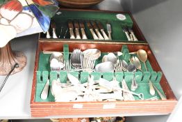 A mahogany canteen containing stainless steel cutlery, A/F