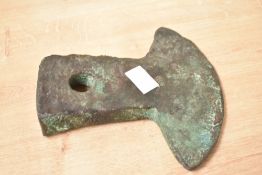 A bronze axe head believed to be pre Columbian Ecuadorian, having flared head and square shaft,