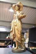 A Goldscheider figure of a Dutch girl carrying a water jug, h66cm