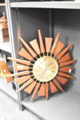 A 20th century Anstey Wilson 'Sunburst' clock, having Quartz movement, brass dial and Roman