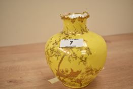 A Royal Crown Derby vase of lobed form, decorated with gilt floral patterns on a yellow ground,