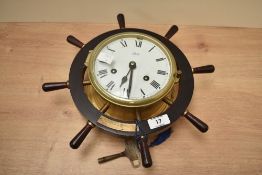 A Schatz 8 day ships bulkhead clock having Roman numerals and shipswheel decoration, H33cm