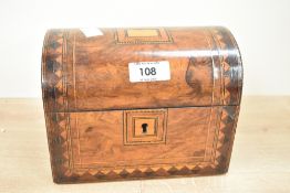A domed top tea caddy decorated with geometrical inlay patterns, the interior fitted with two lidded