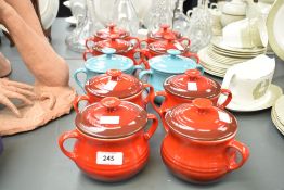 A set of 8 red Le Creuset pots with covers, impressed mark to base, h12cm, sold together with two