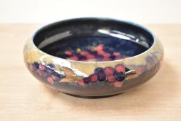 A Moorcroft pottery 'Pomegranate' pattern fruit bowl, decorated with pomegranate, grapes and foliage