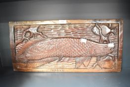 A ethnic hand carved wooden plaque depicting large Pirarucu fish, L57cm