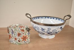 A continental onion pattern blue and white bowl decorated with floral patterns and shaped handles,