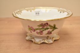 A Spode 'Burtonia' pattern bowl having gilt edges and floral designs, raised on a ruffled foot,