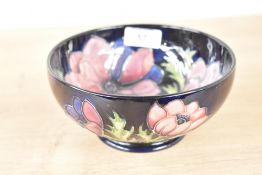 A Moorcroft pottery bowl decorated with poppies on a cobalt blue ground, painted and impressed marks