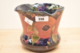 A (William) Moorcroft Pottery Pomegranate pattern vase, of flared baluster form, the rim with
