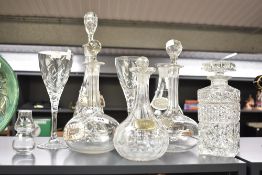 A conical cut-cystal decanter and stopper with two white metal spirit labels, sold along with two