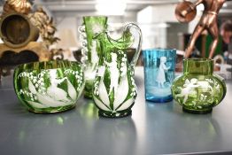 A Mary Gregory type green glass jug hand coloured depicting a boy figure amongst floral and