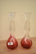 A pair of cranberry to clear glass vases of waisted form, h25.5cm