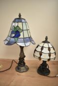 A Tiffany style table lamp, the shade having Art Nouveau floral glass design, h42cm, sold together