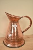 A 19th century copper measure having shaped spout and handle, h29.5cm