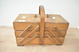 A vintage cantilever sewing box with contents, L32cm