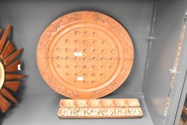 A circular wooden soufaire board having carved patterns, to include tray and stones, W46cm